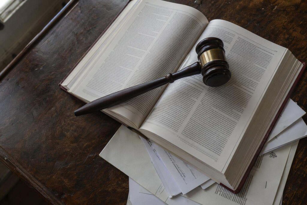 Mazo de juez sobre código penal abierto en mesa de despacho de abogados penalistas Cáceres